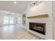 Close-up of a modern fireplace with shiplap accent wall and a rustic wooden mantel at 9985 Lake Forest Way, Roswell, GA 30076
