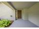 Covered front porch with a stylish front door, and neatly landscaped flower bed at 9985 Lake Forest Way, Roswell, GA 30076