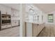 Modern kitchen with stainless steel appliances, white cabinetry and a large island at 9985 Lake Forest Way, Roswell, GA 30076