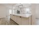 Contemporary kitchen featuring a large island with quartz countertops and stainless steel appliances at 9985 Lake Forest Way, Roswell, GA 30076