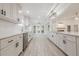 Well-lit kitchen featuring white cabinets, stainless steel appliances, quartz countertops, and modern finishes at 9985 Lake Forest Way, Roswell, GA 30076