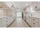 Bright kitchen featuring white cabinetry, stainless steel appliances, and wood look flooring at 9985 Lake Forest Way, Roswell, GA 30076