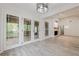 Open living room with fireplace and access to the screened in porch at 9985 Lake Forest Way, Roswell, GA 30076