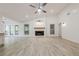 Inviting living room featuring a modern fireplace, light wood flooring, and French doors to the outdoors at 9985 Lake Forest Way, Roswell, GA 30076