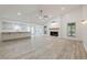 Bright, open-concept living space with fireplace, vinyl floors, and seamless flow to the kitchen at 9985 Lake Forest Way, Roswell, GA 30076