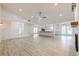 Spacious living room with open floor plan, featuring a fireplace, kitchen access, and large windows at 9985 Lake Forest Way, Roswell, GA 30076