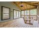 Relaxing screened-in porch with a swing, offering serene outdoor living at 9985 Lake Forest Way, Roswell, GA 30076