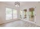 Bright sun room featuring doors that lead to a screened in porch at 9985 Lake Forest Way, Roswell, GA 30076