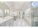 Bright bathroom featuring double vanities, marble countertops, and a glass-enclosed shower and tub at 110 Keswick Way, Alpharetta, GA 30022