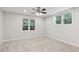 Comfortable bedroom with neutral carpeting and plenty of natural light from the two large windows at 110 Keswick Way, Alpharetta, GA 30022