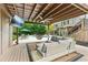 Outdoor patio with a stylish seating area, TV, hanging chair, ceiling fan, and backyard pool at 110 Keswick Way, Alpharetta, GA 30022