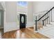 Grand foyer with hardwood floors, staircase, and large windows at 110 Keswick Way, Alpharetta, GA 30022