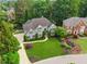 Beautiful two-story home featuring a large manicured lawn and mature trees at 110 Keswick Way, Alpharetta, GA 30022