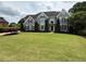 Charming two-story home with a large front yard, manicured lawn, and lush landscaping at 110 Keswick Way, Alpharetta, GA 30022