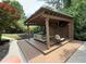 Outdoor gazebo with mounted television, sofa and hanging chair at 110 Keswick Way, Alpharetta, GA 30022