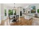 Eat-in kitchen area featuring a modern chandelier, stainless steel appliances, and a granite island at 110 Keswick Way, Alpharetta, GA 30022