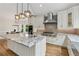 Kitchen with large island, stainless steel appliances, modern lighting, and granite countertops at 110 Keswick Way, Alpharetta, GA 30022