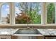 Close-up of kitchen sink, granite countertop, and a view of the backyard at 110 Keswick Way, Alpharetta, GA 30022