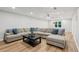 Spacious living room featuring a large sectional sofa, hardwood floors, and recessed lighting at 110 Keswick Way, Alpharetta, GA 30022