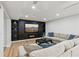 Cozy living room featuring a large TV, fireplace, recessed lighting, and a comfortable sectional sofa at 110 Keswick Way, Alpharetta, GA 30022