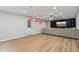 Modern living room features a large TV, hardwood floors, and a comfortable sectional sofa for relaxation at 110 Keswick Way, Alpharetta, GA 30022