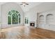 Spacious living room with a vaulted ceiling, fireplace, built-in shelving, and large windows at 110 Keswick Way, Alpharetta, GA 30022