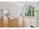 Bright and open living room with hardwood floors, a large arched window, and access to the backyard at 110 Keswick Way, Alpharetta, GA 30022