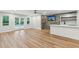 Entertainers living room features a wet bar, hardwood floors, and glass doors leading to the pool area at 110 Keswick Way, Alpharetta, GA 30022