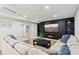 Inviting living room showcasing a TV, fireplace, hardwood floors, and a comfortable sectional sofa at 110 Keswick Way, Alpharetta, GA 30022