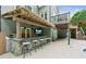 The outdoor kitchen is equipped with a grill, sink, and seating and is great for entertaining at 110 Keswick Way, Alpharetta, GA 30022