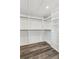 Spacious walk-in closet with custom shelving and hardwood floors perfect for organizing your wardrobe at 110 Keswick Way, Alpharetta, GA 30022