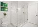 Bright bathroom features a large glass enclosed shower with white marbled tile and a view from the window at 2813 Hillside Rd, Smyrna, GA 30080