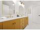 Stylish bathroom with a double vanity, gold fixtures, and bright, modern lighting at 2813 Hillside Rd, Smyrna, GA 30080