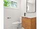 Modern bathroom boasts wood vanity, sleek black faucet, and large mirror at 2813 Hillside Rd, Smyrna, GA 30080