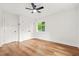 Bright bedroom featuring hardwood floors, ceiling fan, and natural light streaming in from the window at 2813 Hillside Rd, Smyrna, GA 30080