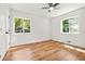 Bedroom features two large windows with views, ceiling fan, and hardwood flooring at 2813 Hillside Rd, Smyrna, GA 30080