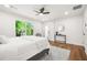 Well-lit bedroom with modern decor, a ceiling fan, and a view of the outdoors at 2813 Hillside Rd, Smyrna, GA 30080