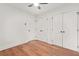 The bright bedroom with hardwood floors features multiple closets and a ceiling fan at 2813 Hillside Rd, Smyrna, GA 30080