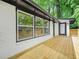 Side of house features a light wood deck with white painted brick exterior, black trim and a glass paned door at 2813 Hillside Rd, Smyrna, GA 30080