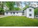 Newly renovated home with fresh white paint, contrasting black trim, and bright green lawn at 2813 Hillside Rd, Smyrna, GA 30080