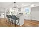 Modern kitchen with white cabinets, stainless steel appliances, a kitchen island, and hardwood floors at 2813 Hillside Rd, Smyrna, GA 30080