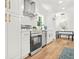 Bright modern kitchen with white cabinetry, stainless steel appliances, and hardwood floors at 2813 Hillside Rd, Smyrna, GA 30080
