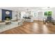 Open-concept living room with hardwood floors and a modern kitchen in the background at 2813 Hillside Rd, Smyrna, GA 30080