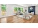 Bright living room featuring hardwood floors, a neutral color palette, and a cozy fireplace with blue accent wall at 2813 Hillside Rd, Smyrna, GA 30080