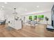 Modern living room with hardwood floors, a neutral color scheme, and an open layout connecting to the kitchen at 2813 Hillside Rd, Smyrna, GA 30080