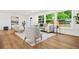 Bright living room featuring hardwood floors, a neutral color palette, and large windows with a lush green view at 2813 Hillside Rd, Smyrna, GA 30080