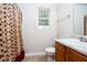 Cozy bathroom featuring a vanity, toilet, and shower with a patterned curtain at 5857 Cobalt Dr, Powder Springs, GA 30127