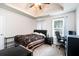 Bedroom with tray ceiling, comfortable bed, and office space by window at 5857 Cobalt Dr, Powder Springs, GA 30127
