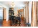Bright dining area featuring wood floors, black dining set, and natural light from large windows at 5857 Cobalt Dr, Powder Springs, GA 30127