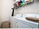 Laundry room featuring a washer, dryer, and shelving for supplies at 5857 Cobalt Dr, Powder Springs, GA 30127